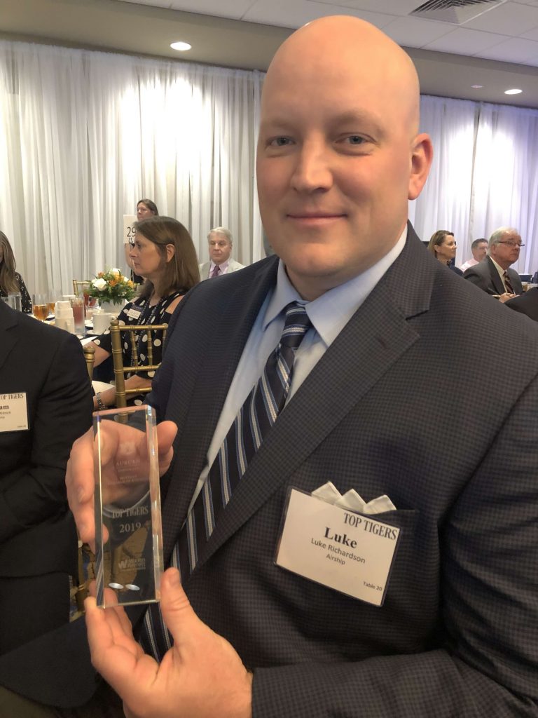 Luke Richardson, Lead Opportunity Explorer at Airship, holding the 2019 Top Tigers Award from Auburn University